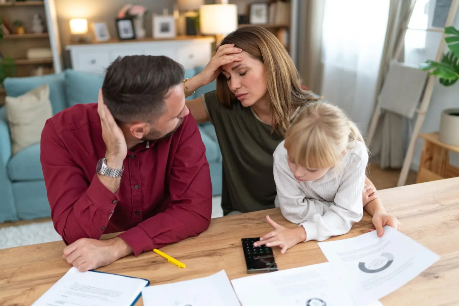 Young family with a daughter feeling stressed managing budget and paying bills and taxes